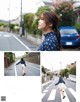 A woman walking across a street next to a blue car.