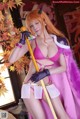 A woman in a pink bikini holding a sword.