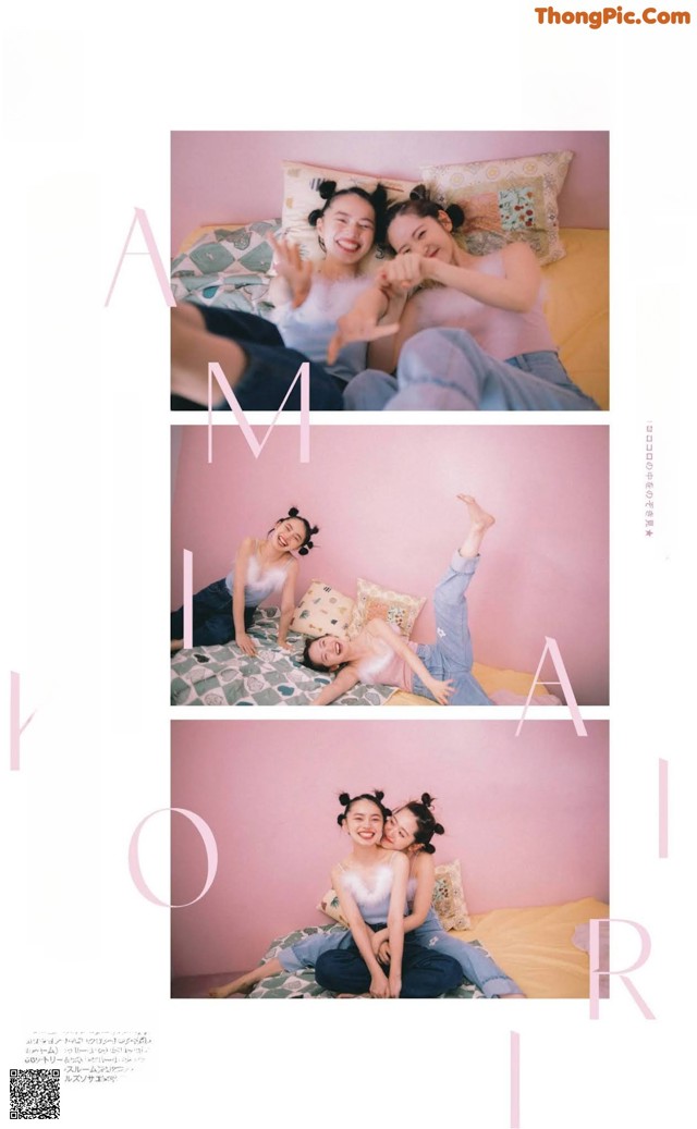 A couple of women laying on top of a bed.